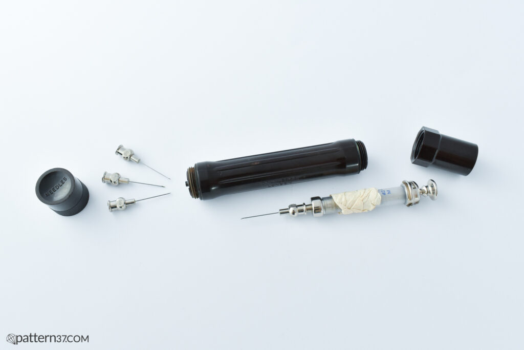 Syringe in bakelite case